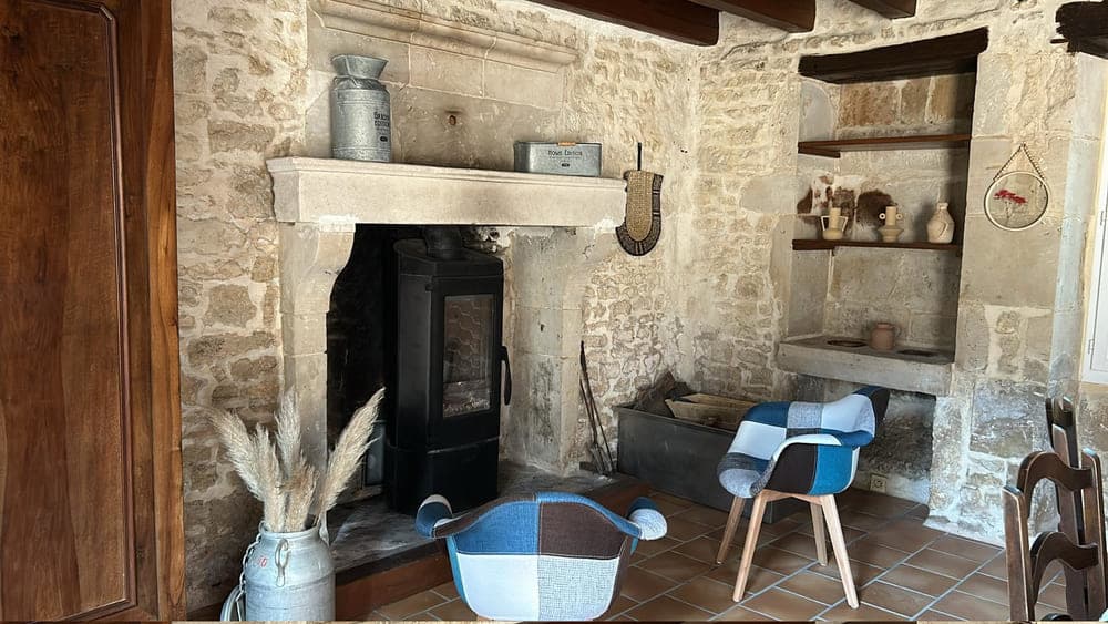 Le charmant coin cheminée du salon du Gîte Pampas au Domaine du Vieux Lavoir, avec ses deux chaises confortables, invitant à la détente. Cet espace chaleureux est parfait pour se ressourcer après les festivités de vos mariages et grandes réceptions dans les Deux-Sèvres, offrant un cadre cosy et accueillant pour vos invités séjournant sur place.